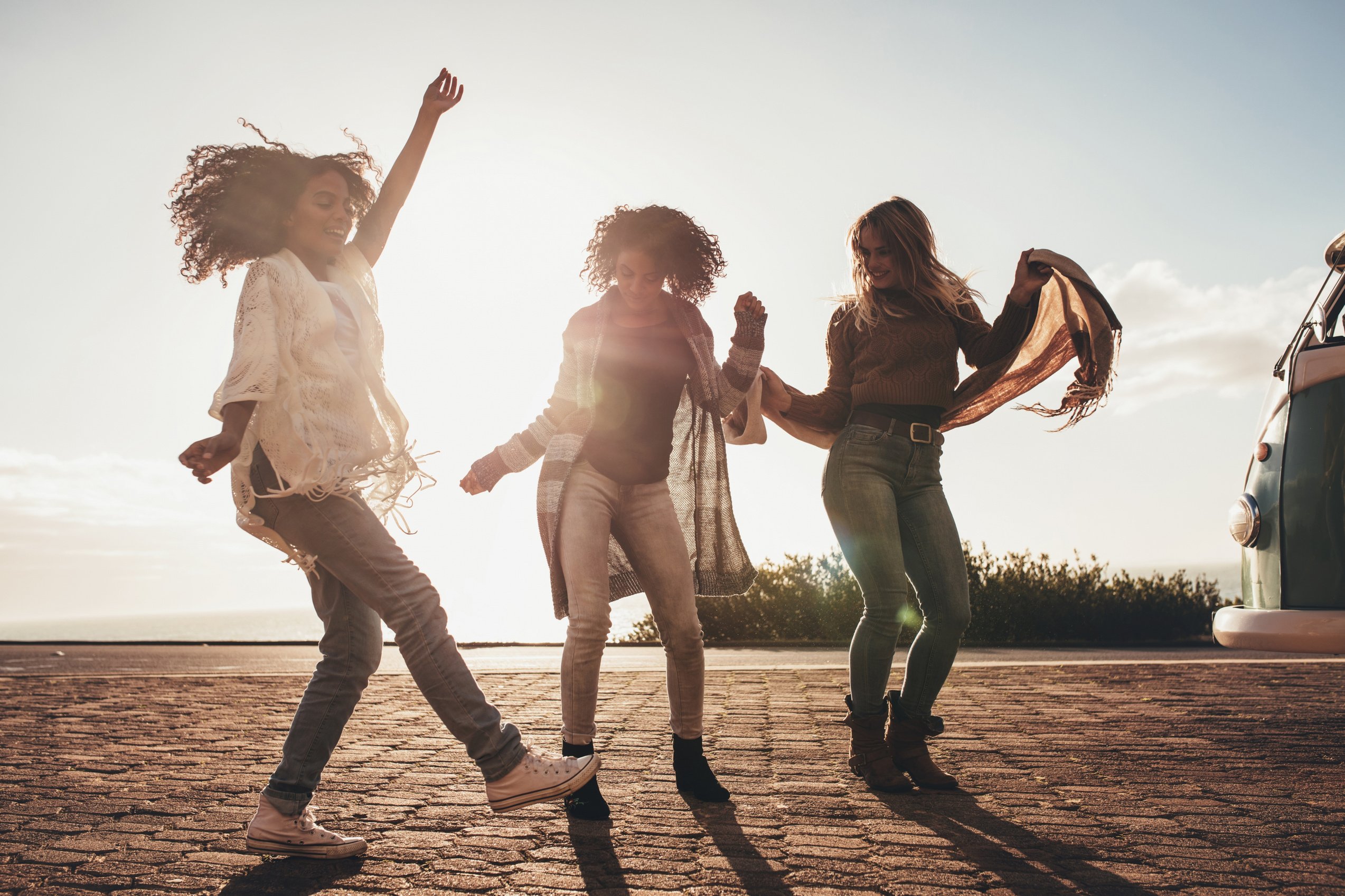 Women Dancing on Road Trip